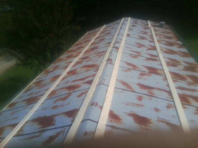 Rusted metal roof panels with new wood purlins before replacement — Storm Damage Roof Repair in Sequatchie by Roofing Brothers