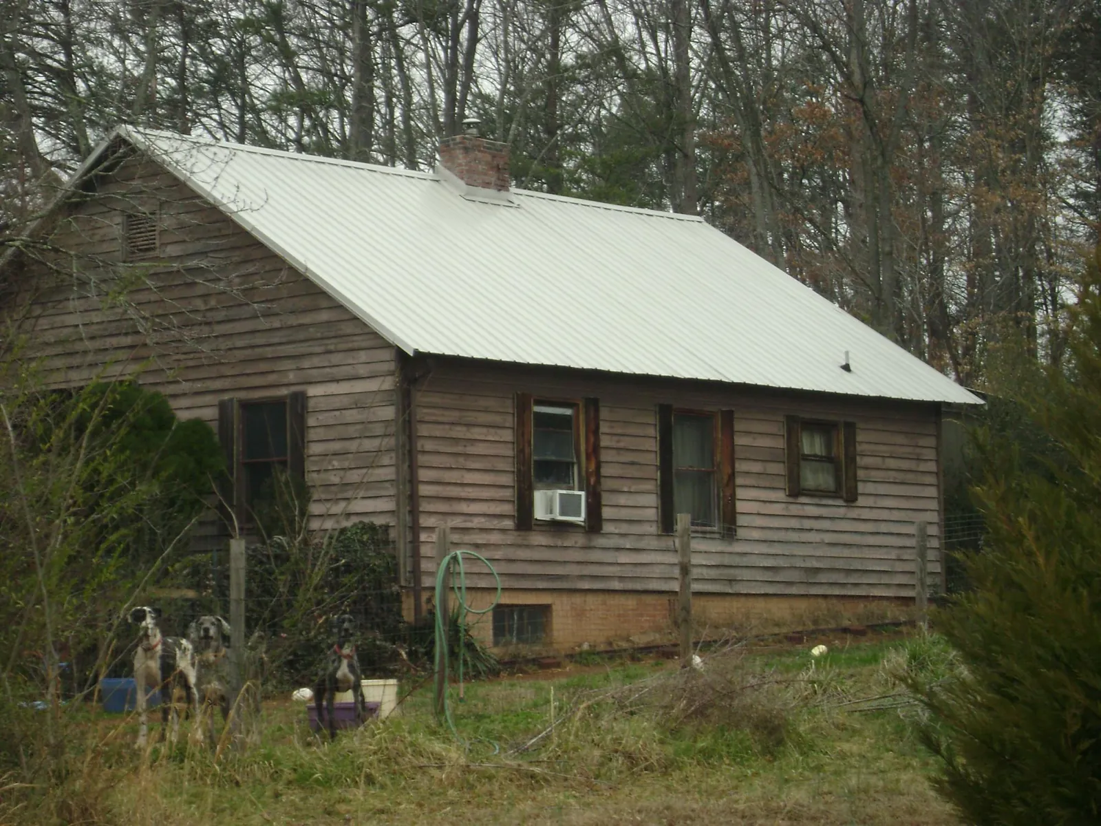White metal roof on an old wood sided farmhouse, from a Metal Roof Installation job in Sequatchie